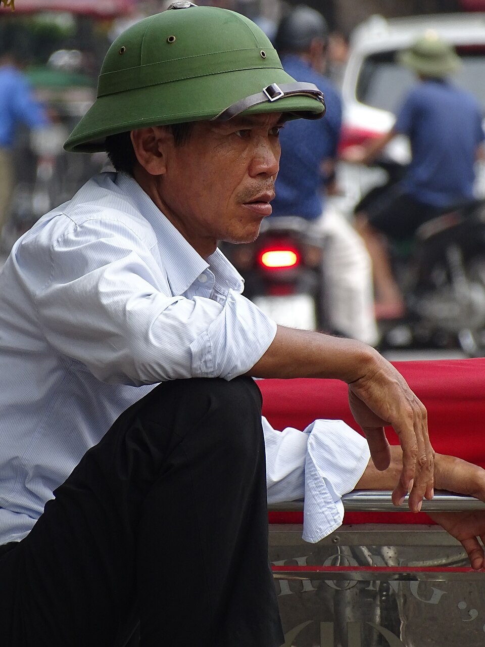man-in-pith-helmet-on-bike-old-quarter-hanoi-vietnam-48071261636-171715-1787639402.jpg